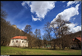 Poničený kostel a hrad Čabraď nad ním na hadím vrchu